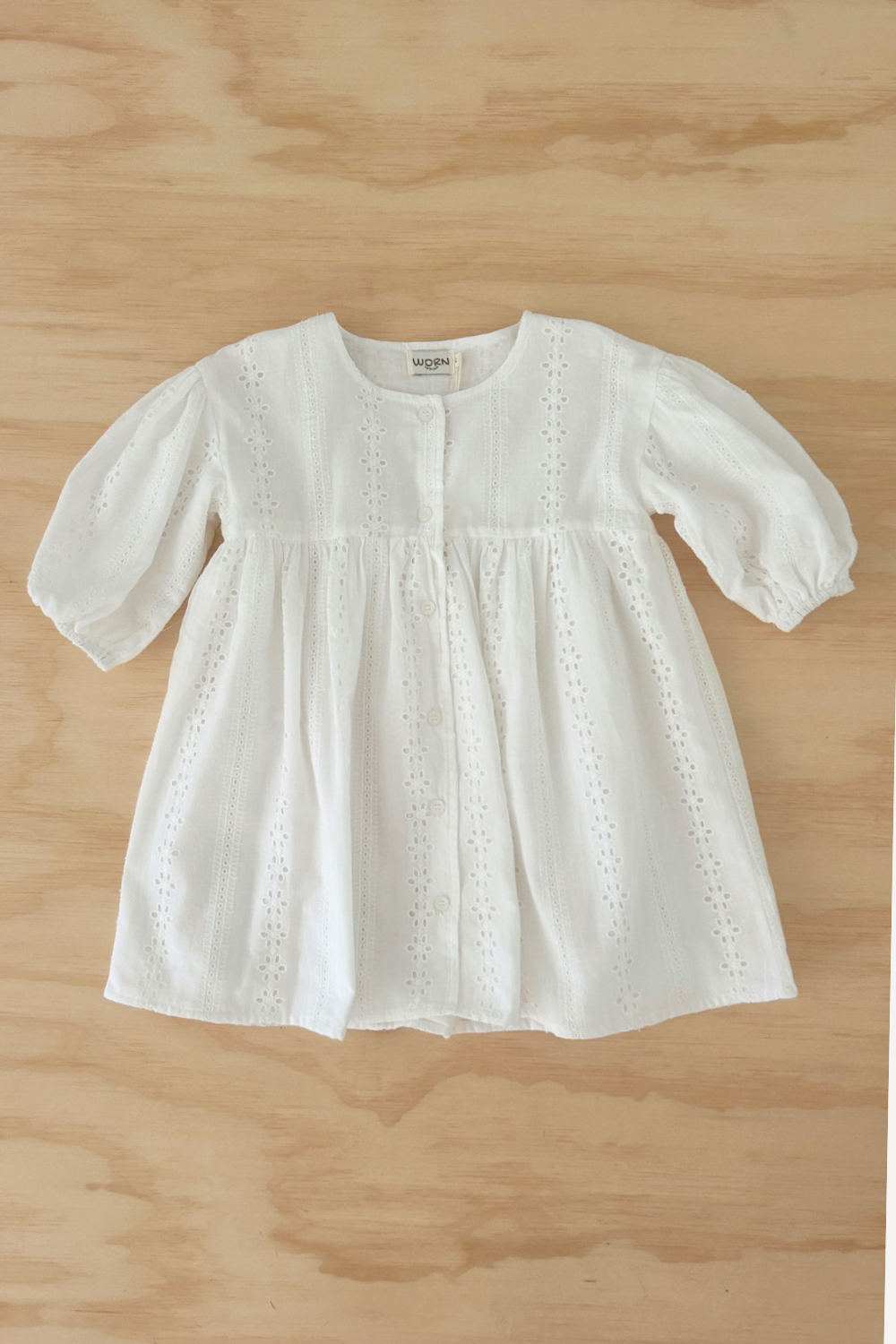 Front view of Girls Sunday Smock Dress in Milk White – Cotton Broderie